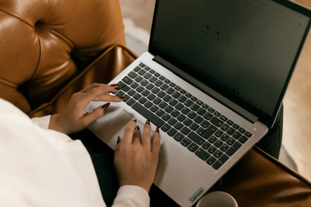 Person searching image on laptop