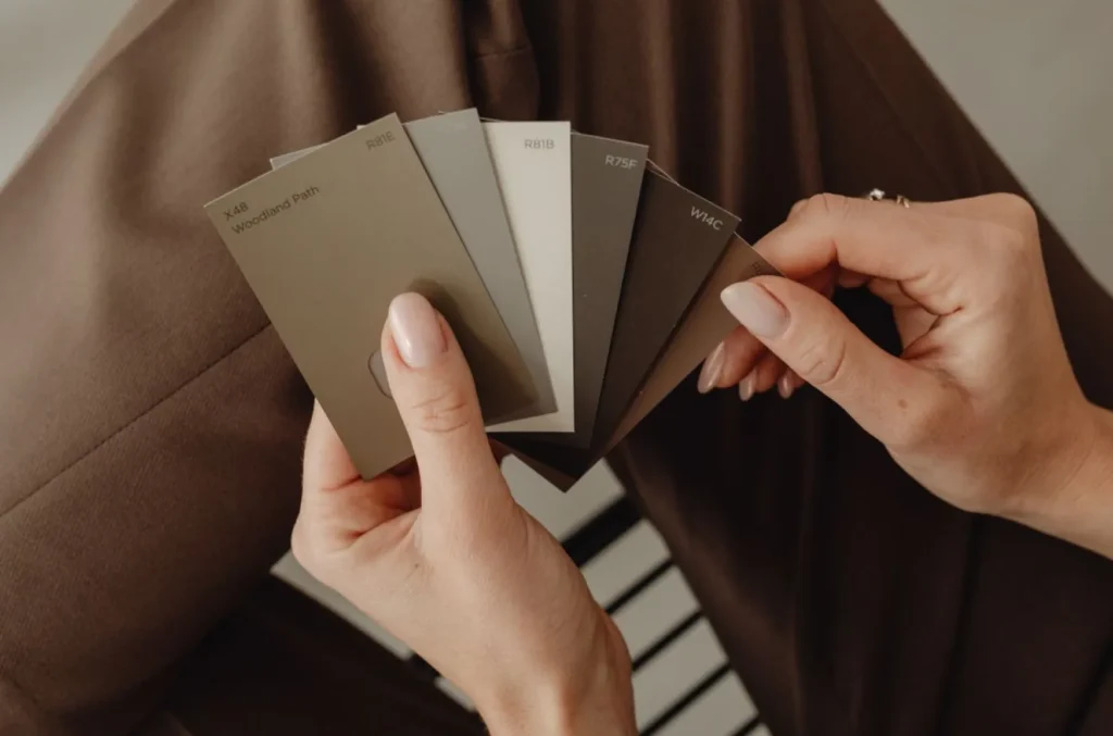 A woman is holding colour swatches